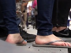 Candid barefoot shoeplay in flip-flops