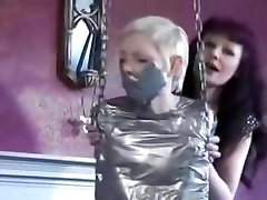 Blonde girl completely tape mummified to swing
