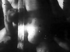 Grainy black and white footage of woman with nice boobs fucking and sucking