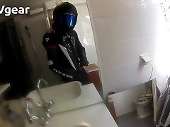 biker in revit race leathers rubs his bulge in the bathroom
