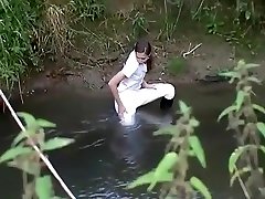 Girl gets wet in creek in riding attire
