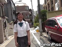 Young Japanese schoolgirl pisses her baited escorts outdoor