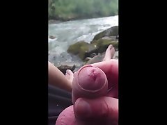 wank outdoor at the mountain river
