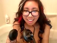 Asian teen plays with her pussy in a bathtub