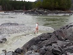 girlfriend in sel pake sex lickinq sperm and heels posing by the river. a photo