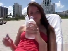 Tori houes girls is outdoors at the beach getting a tan