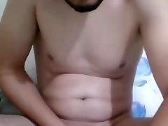 handsome bearded straight guy jerking off his uncut cock