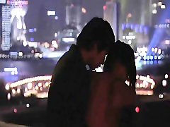 Bai Ling making out with a guy as he opens her red shirt to