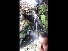 naked in public, nudism. showering in a stylish summer fashion style waterfall.