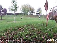 Amateur Brunette Stands And Pees Over The Grass
