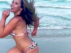 Mickie James running on a beach in a bikini. WWE, TNA.