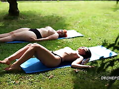 Two fantasy toys girls sunbathing in the city park