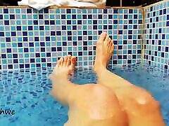 Feet in the pool with water