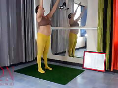 Regina Noir. Yoga in yellow tights in the gym. A girl without bollywood movie scences is doing yoga. Cam 2
