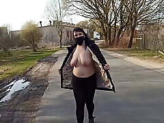 Naked, shameless wife walks down the street in a testis on leg place