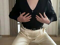 Sissy gay in satin silk palazzo wide leg trousers and black romantic women blouse on high heels overknee boots dancing