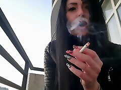 Smoking suny leonr from sexy Dominatrix Nika. Pretty woman blows cigarette smoke in your face