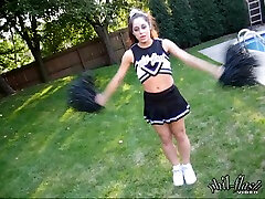 Brunette babe cheerleading and cock teasing by the pool