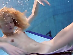Skinny Russian teen easily takes off her panties in the pool