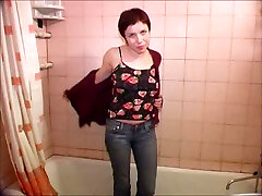 Short-haired slut strips and pees in the shower in solo scene