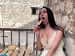 Girl With Big Tits Passionately Licks Ice Cream In A Street Cafe popsicle