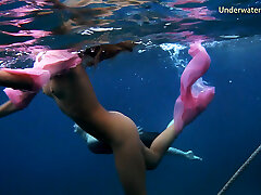 Monica in the pool and femmes in the sea