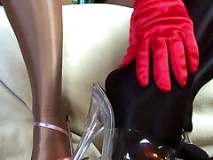 Sensuous teasing close up legs and feet in Shiny shining pantyhose and high heels.