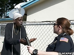 Two slutty police officers take advantage over dark-hued scofflaw