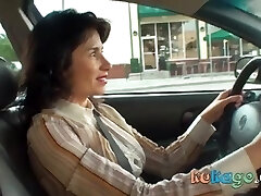 Horny brown-haired woman in the car