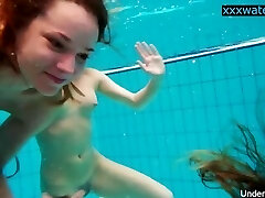 Hot gals undress in the pool