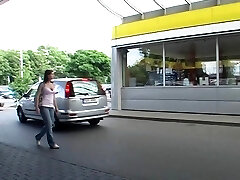 In a public bathroom she deepthroats a cock thru a gloryhole