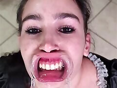 French maid tries to swallow her own piss through lip retractor