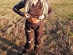 A Girl with a Beautiful Body Poses in a Field