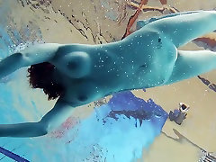 Redheaded Katrin is stripping underwater