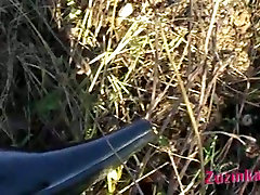 Perverse slut sits on lawn and gets her twat poked with blade