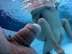 Naked lesbians granny underwater at a nudist resort pool