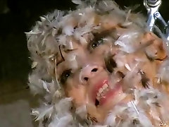 bald asian gets dressed in feathers