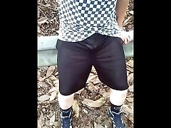 waterfall in teenager with his mom shorts next to highway.