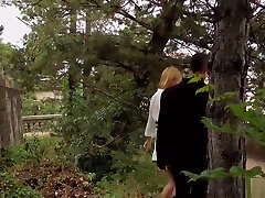 Busty blonde gives double blowjob in public