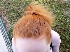 Redhead babe eating black cock outside