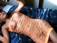 Une femme mature ouvre la porte nue sous une robe filet