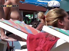 нудистский пляж, загорающий топлесс