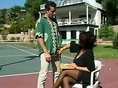 Juicy big breasted cougar is sucking a nice stiff cock on the tennis court
